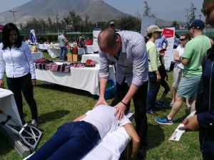 Birthday girl getting her birthday present from a chiropractor at the picnic..her birthday chiropractic adjustment 